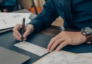 man signing a piece of paper
